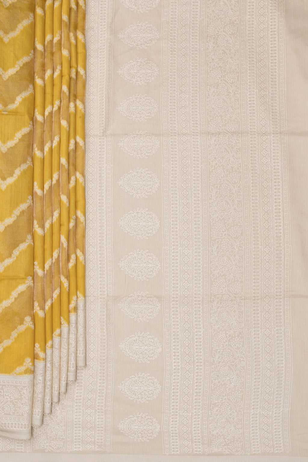 Pleats and pallu of Yellow Tussar Saree with Zari Brocade on the body and Embroidered Border. 