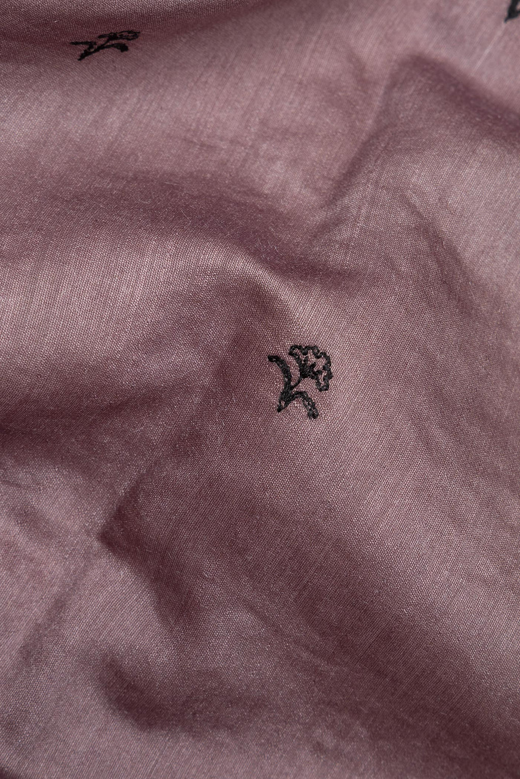 Close up of Brown Tussar Saree with Embroidered on the body and Embroidered Border.  displaying folds