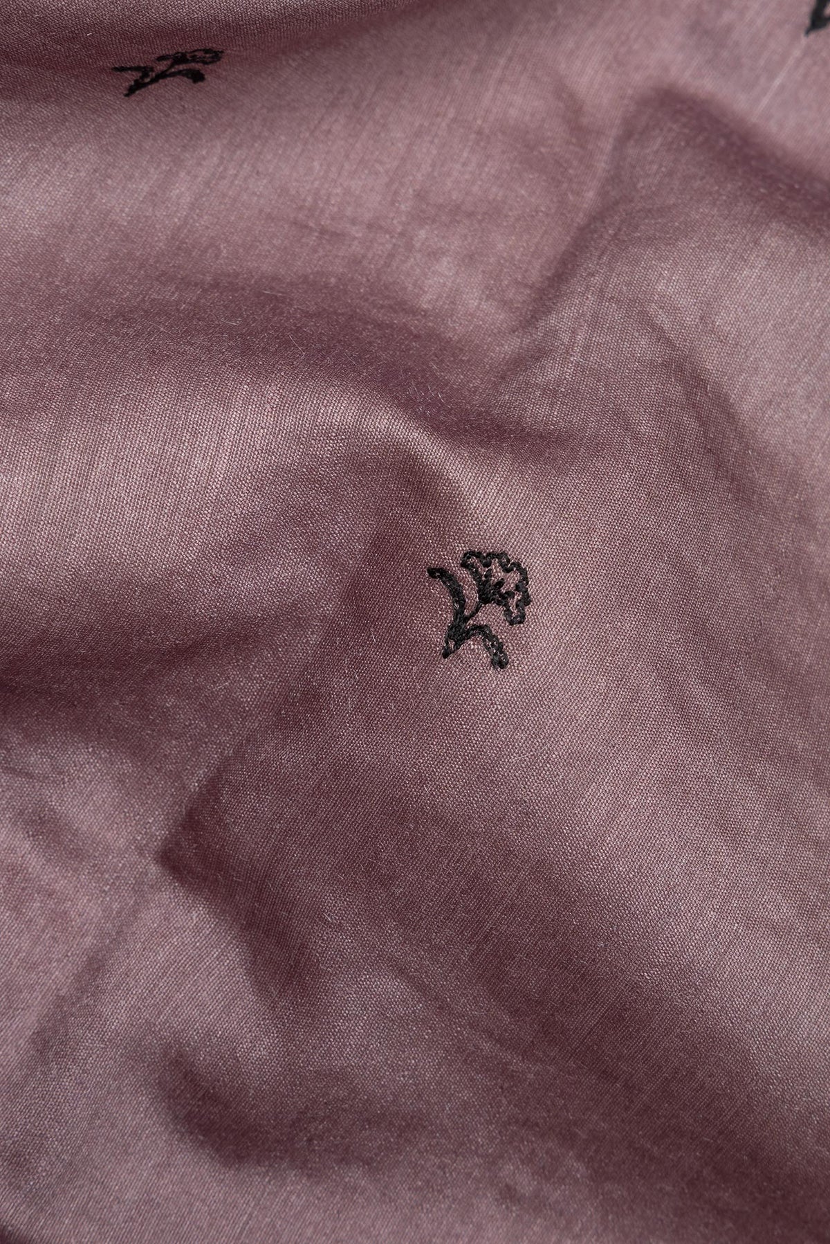 Close up of Brown Tussar Saree with Embroidered on the body and Embroidered Border.  displaying folds