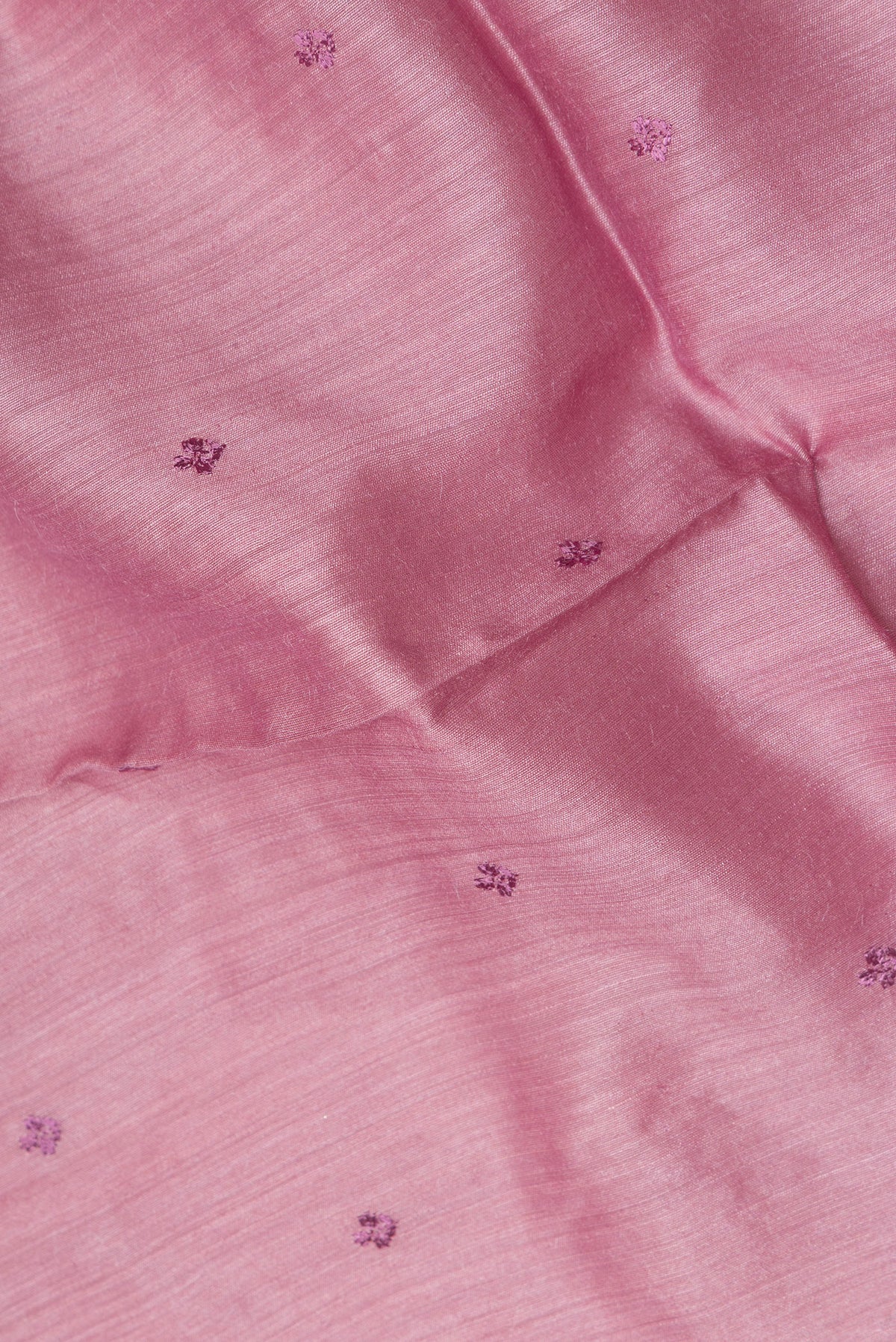 Close up of Pink Tussar Saree with Embroidered on the body and Embroidered Border.  displaying folds