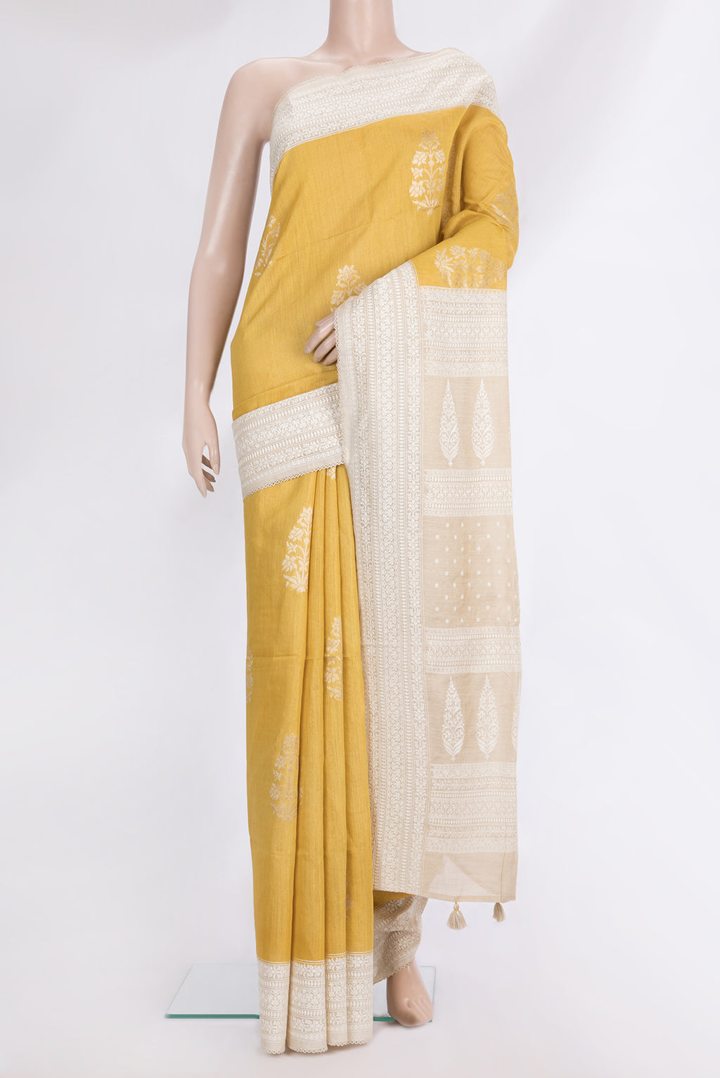 Pure Silk Yellow Tussar Saree with Zari Butta on the body and Embroidered Border.  displayed on a mannequin