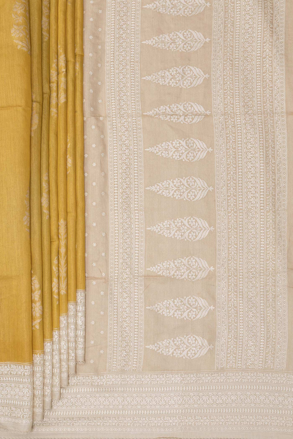 Pleats and pallu of Pure Silk Yellow Tussar Saree with Zari Butta on the body and Embroidered Border. 
