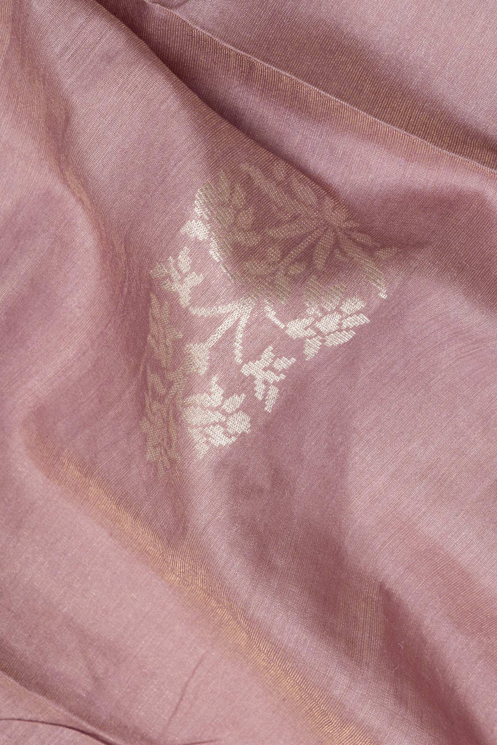 Close up of Pure Silk Rose Gold Dual Tone Tussar Saree with Zari Butta on the body and Embroidered Border.  displaying folds