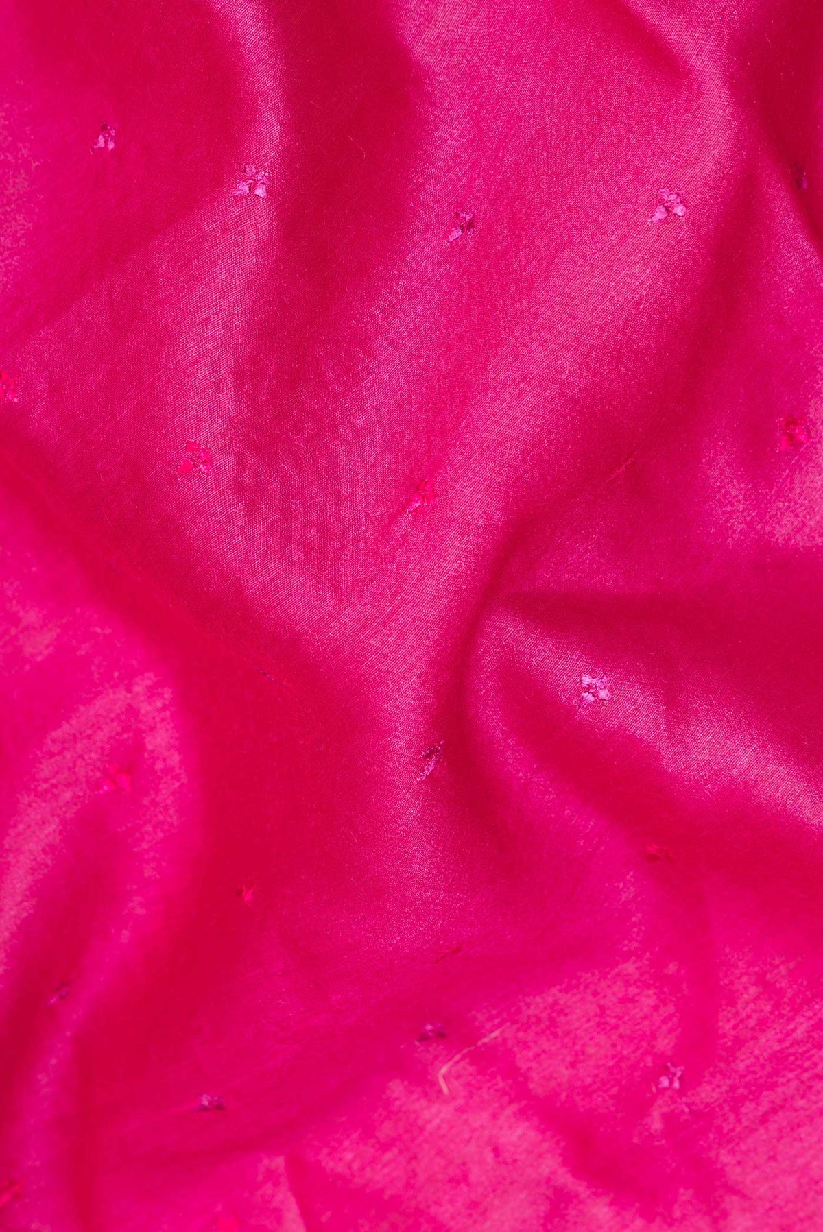 Close up of Pure Silk Dark Pink Tussar Saree with Embroidered on the body and Embroidered Border.  displaying folds