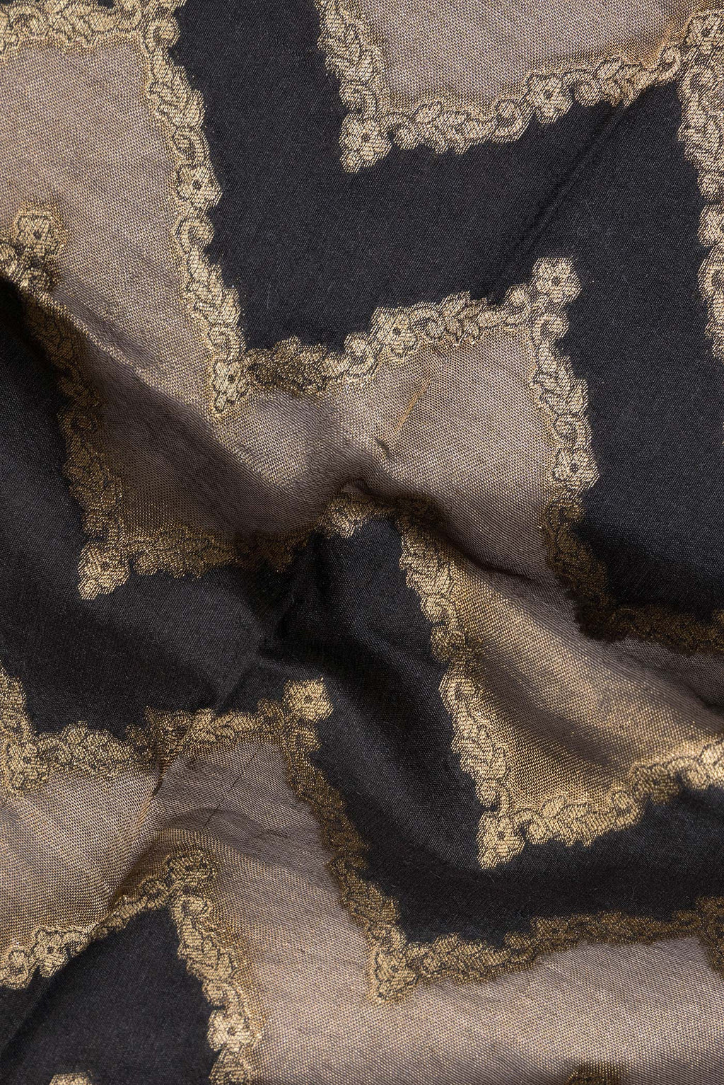 Close up of Black Tussar Saree with Zari Brocade on the body and Embroidered Border.  displaying folds