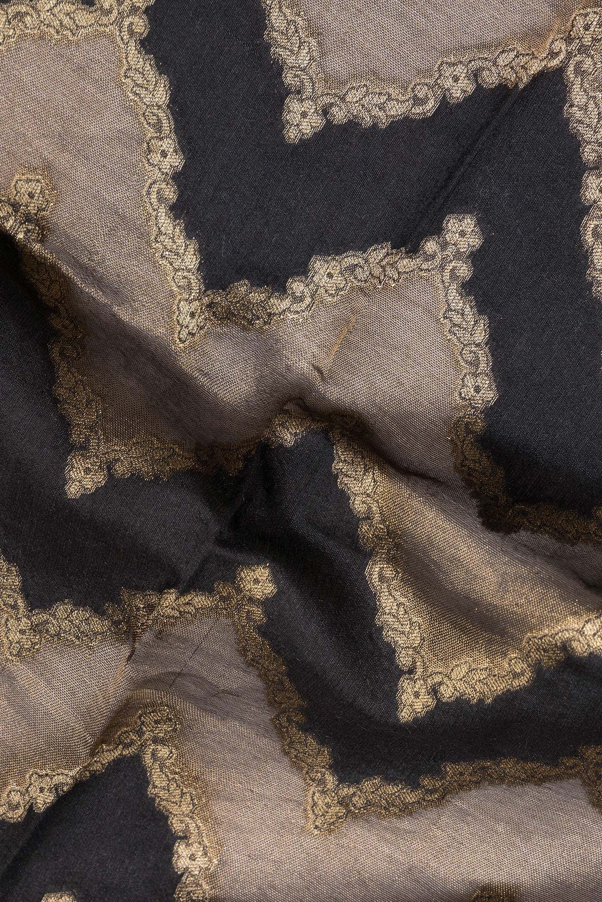 Close up of Black Tussar Saree with Zari Brocade on the body and Embroidered Border.  displaying folds