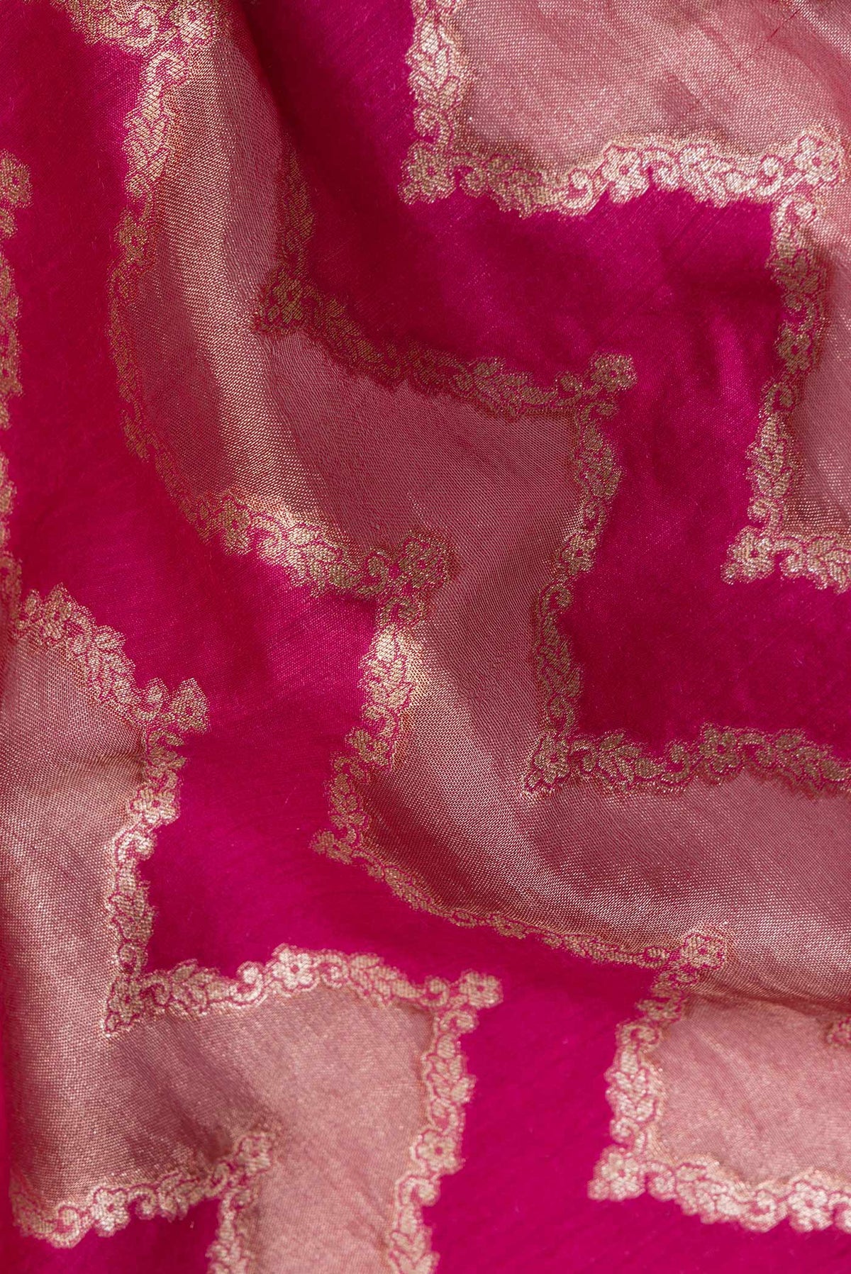 Close up of Pure Silk Dark Pink Dual Tone Tussar Saree with Zari Brocade on the body and Embroidered Border.  displaying folds