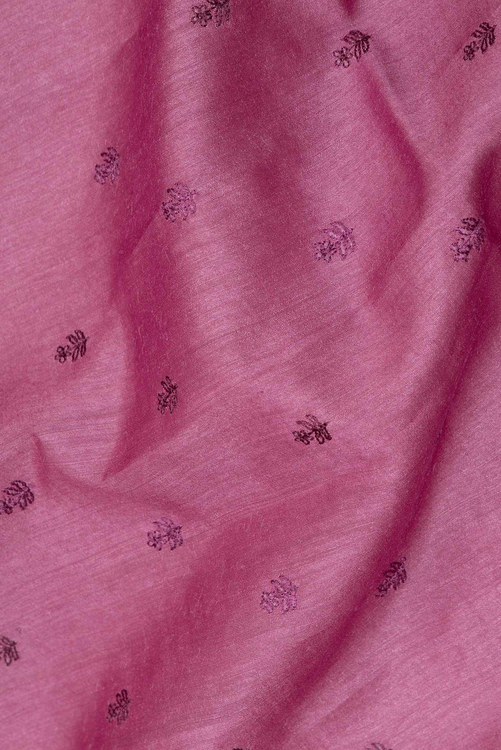Close up of Pure Silk Pink Tussar Saree with Embroidered on the body and Embroidered Border.  displaying folds