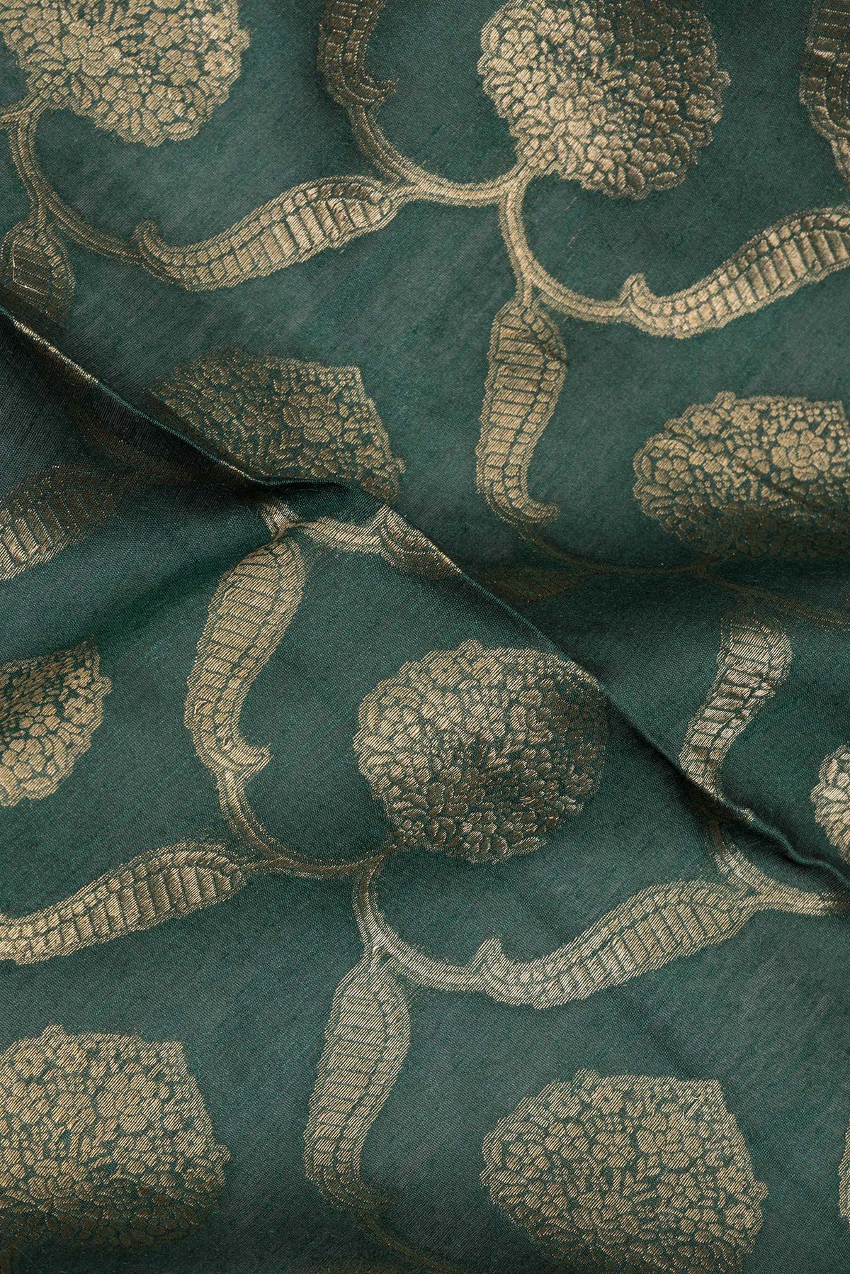 Close up of Bottle Green Tussar Saree with Zari Brocade on the body and Embroidered Border.  displaying folds