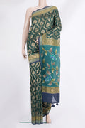 Bottle Green Tussar Saree with Zari Brocade on the body and Embroidered Border.  displayed on a mannequin