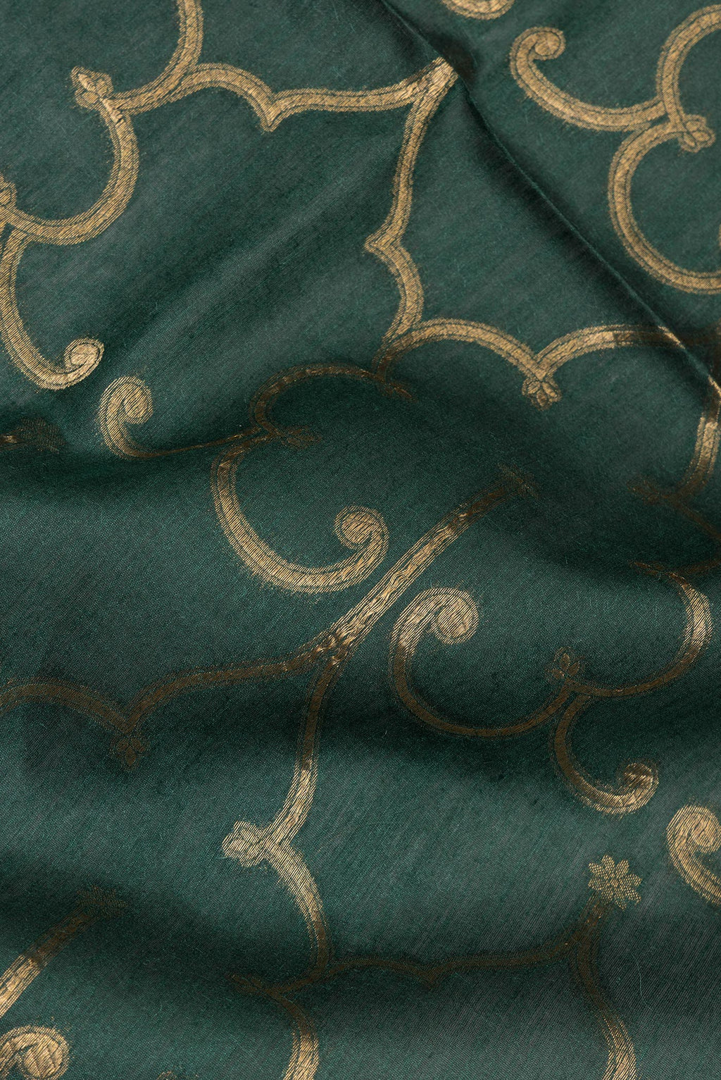 Close up of Bottle Green Tussar Saree with Zari Brocade on the body and Embroidered Border.  displaying folds