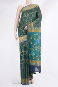 Bottle Green Tussar Saree with Zari Brocade on the body and Embroidered Border.  displayed on a mannequin