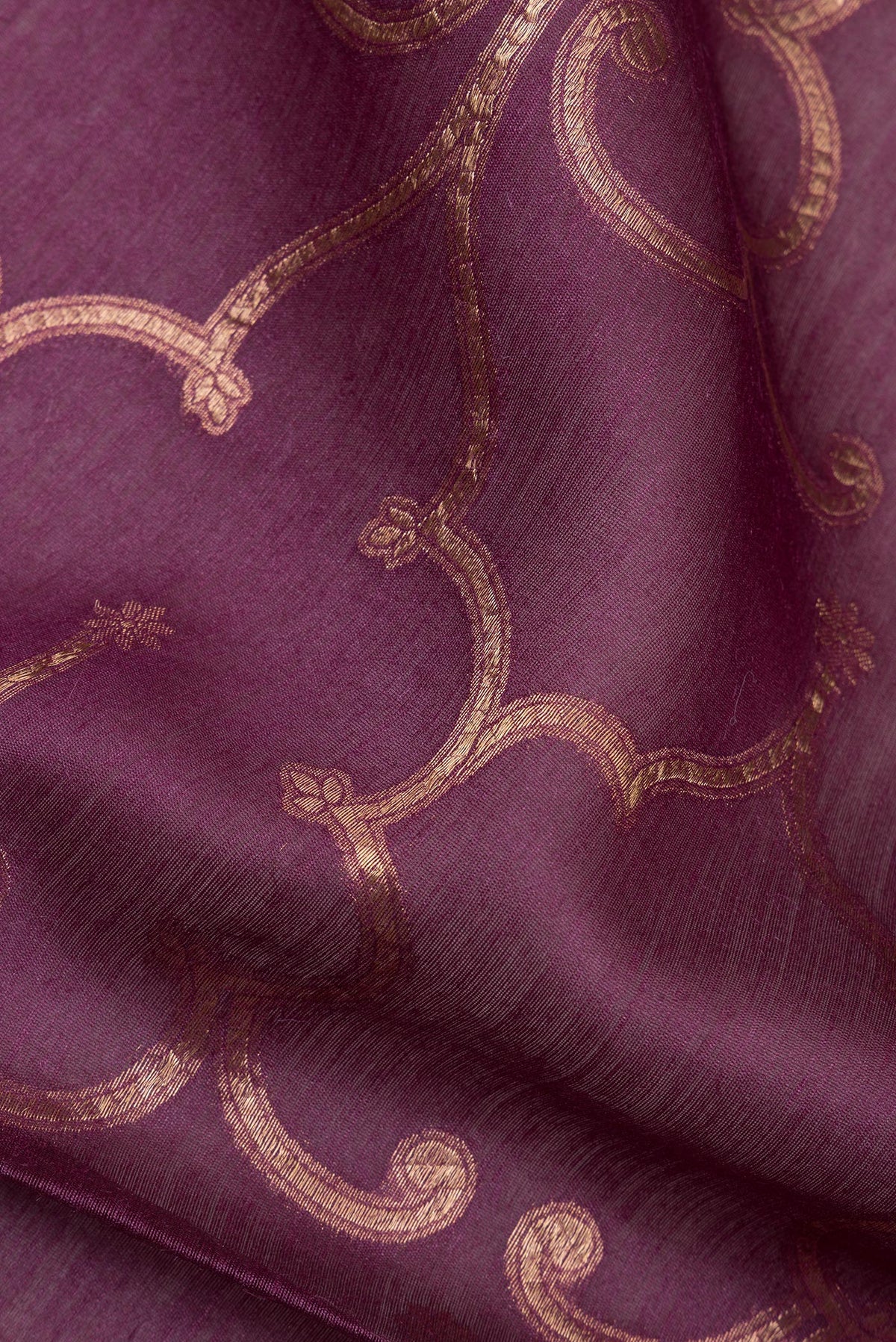 Close up of Pure Silk Mauve Tussar Saree with Zari Brocade on the body and Embroidered Border.  displaying folds