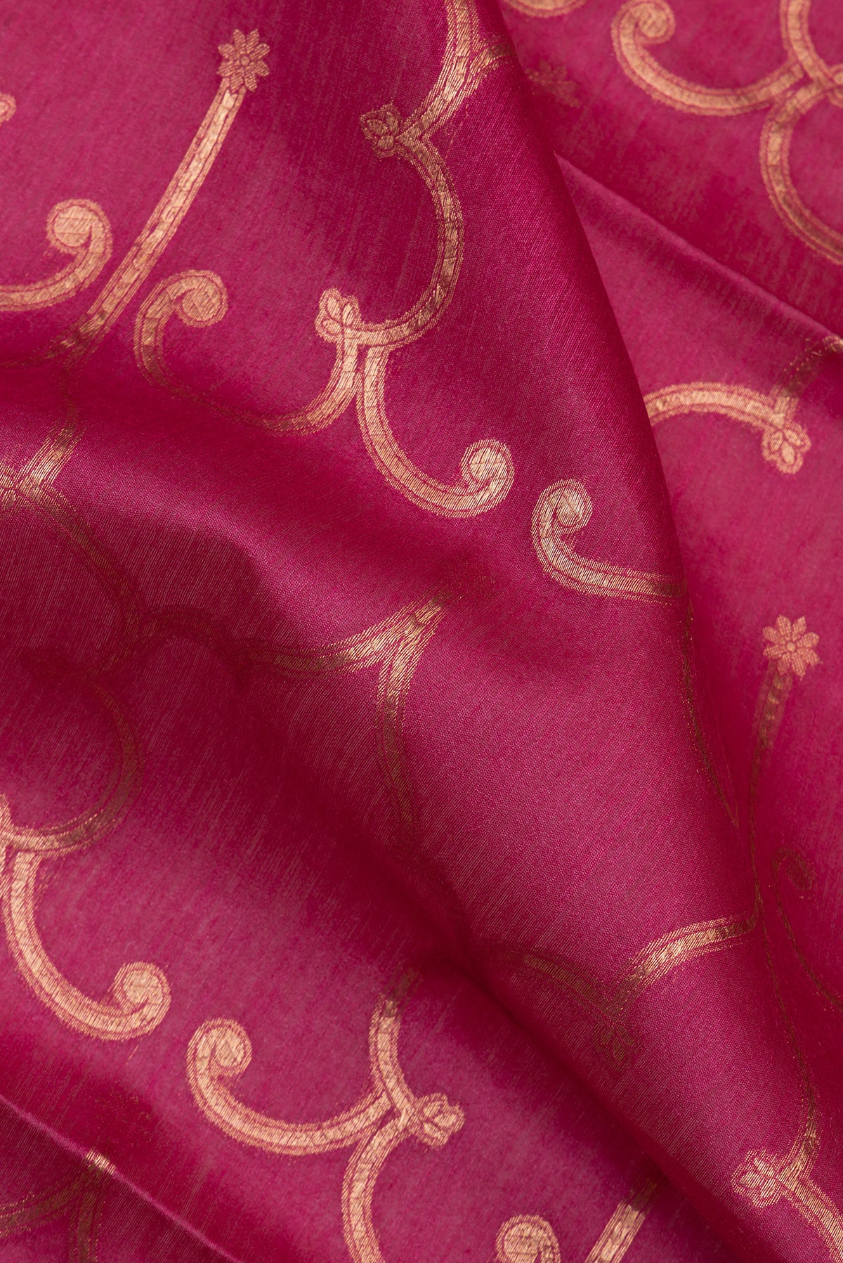 Close up of Dark Pink Tussar Saree with Zari Brocade on the body and Embroidered Border.  displaying folds