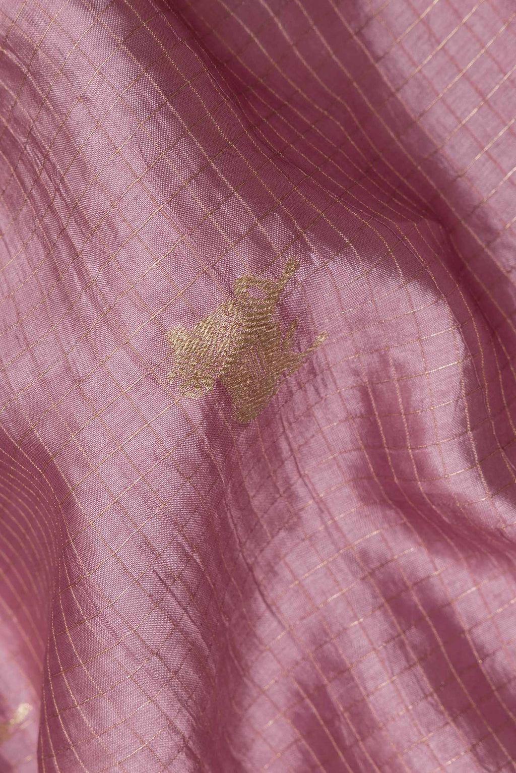 Close up of Pure Silk Rose Gold Tussar Saree with Checked design on the body and Embroidered Border.  displaying folds