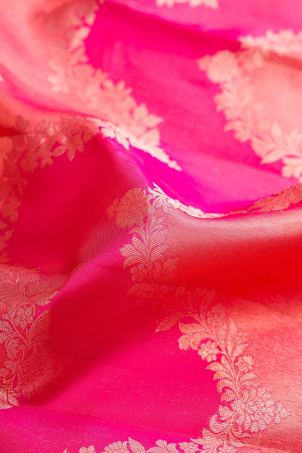 Close up of Pure Silk Pink Dual Tone Kanjivaram Saree with Zari Brocade on the body and Fancy Border.  displaying folds