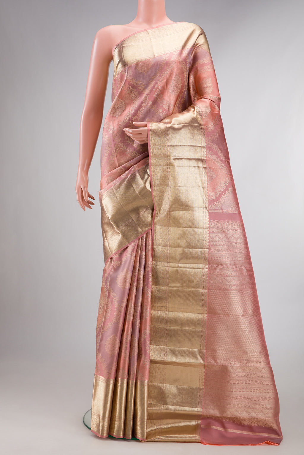 Pure Silk Rose Gold Dual Tone Kanjivaram Saree with Zari Brocade on the body and Zari Border.  displayed on a mannequin