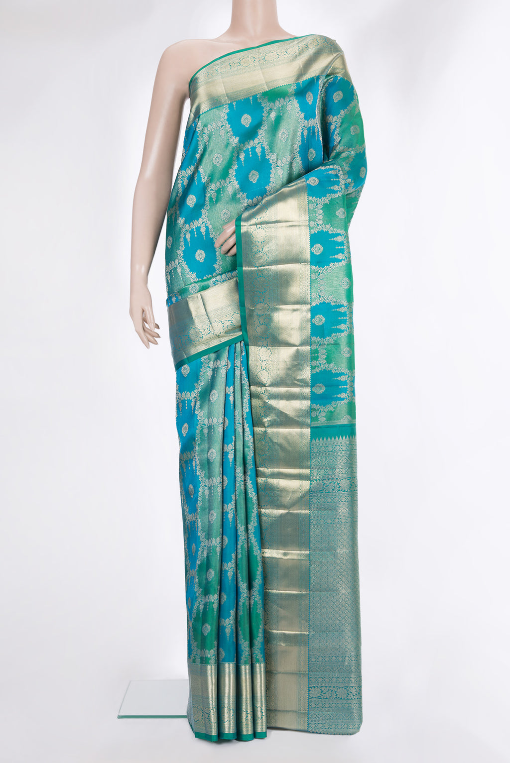 Pure Silk Sea Green and Peacock Blue Color Kanjivaram Saree with Zari Brocade on the body and Zari Border.  displayed on a mannequin