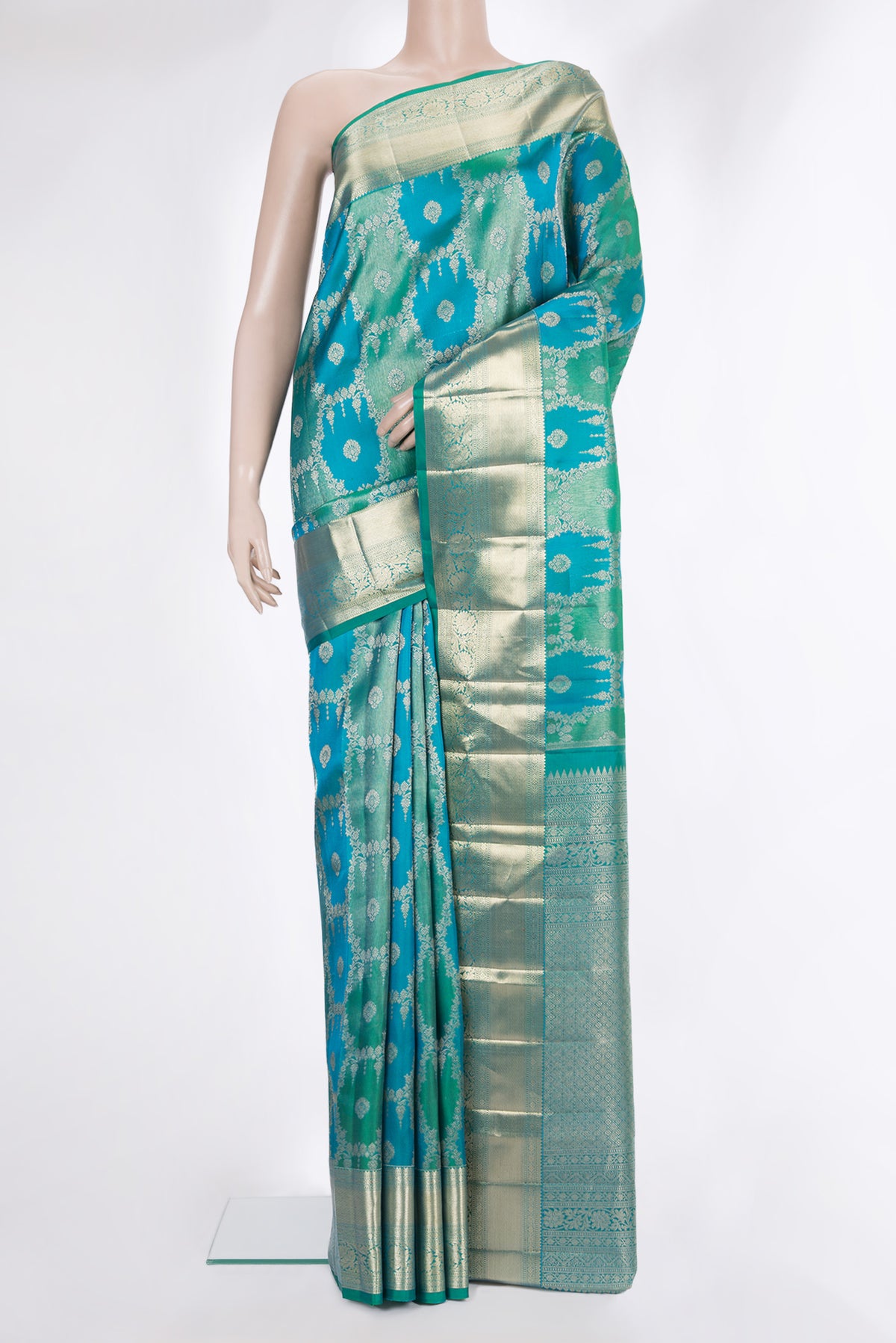 Pure Silk Sea Green and Peacock Blue Color Kanjivaram Saree with Zari Brocade on the body and Zari Border.  displayed on a mannequin