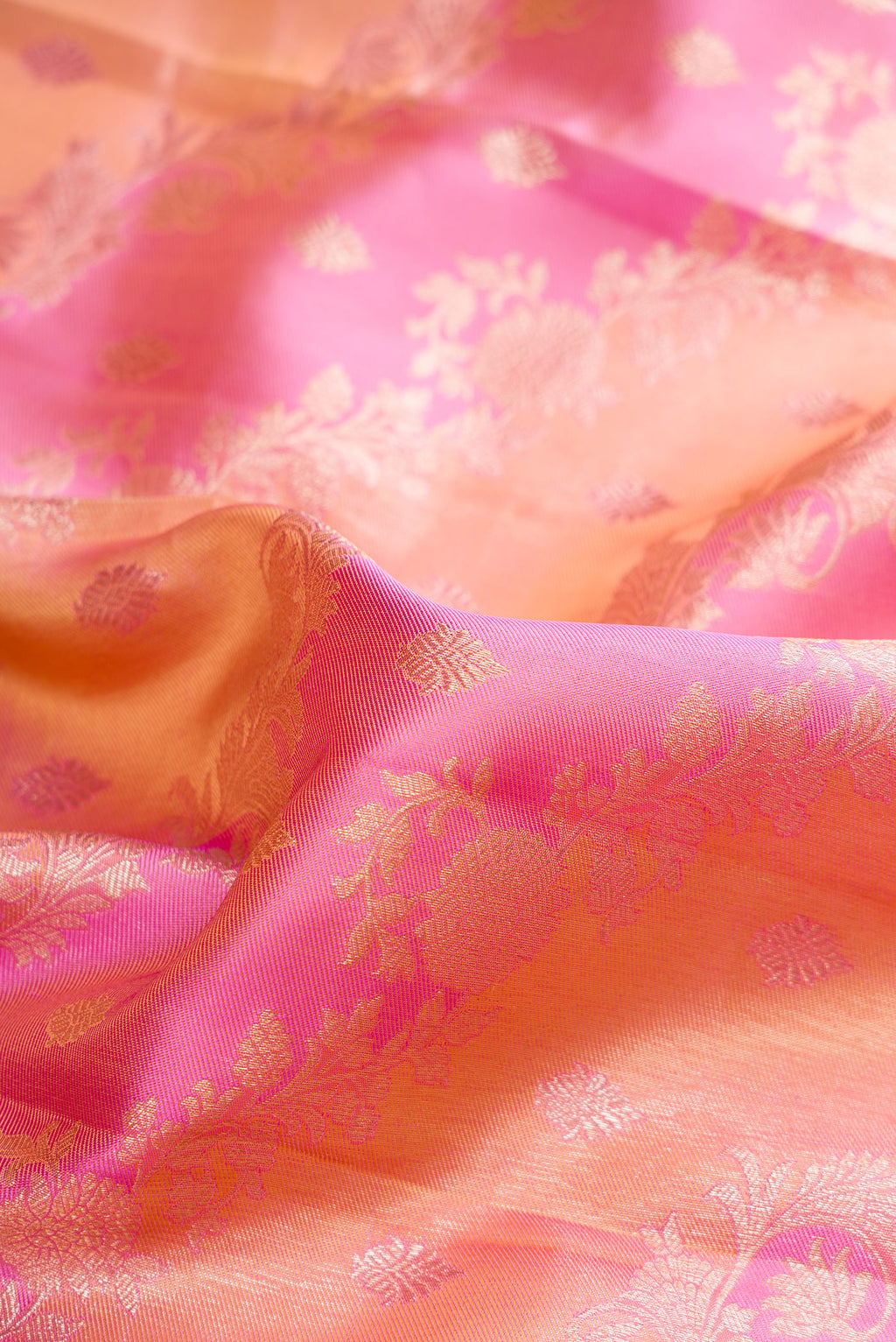 Close up of Pure Silk Pink and Peach Color Kanjivaram Saree with Zari Brocade on the body and Zari Border.  displaying folds