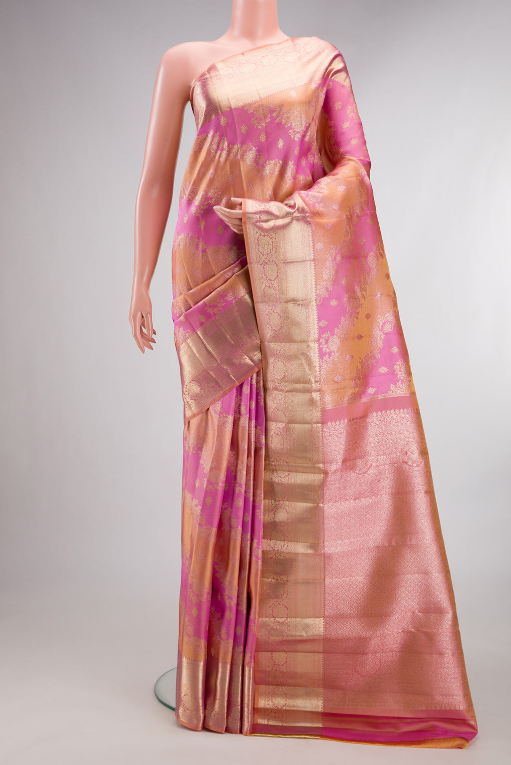 Pure Silk Pink and Peach Color Kanjivaram Saree with Zari Brocade on the body and Zari Border.  displayed on a mannequin