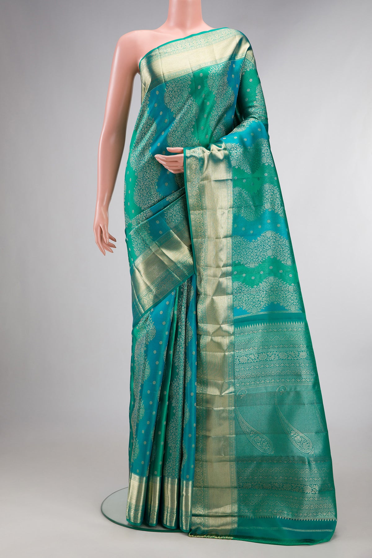 Pure Silk Sea Green Dual Tone Kanjivaram Saree with Zari Brocade on the body and Zari Border.  displayed on a mannequin