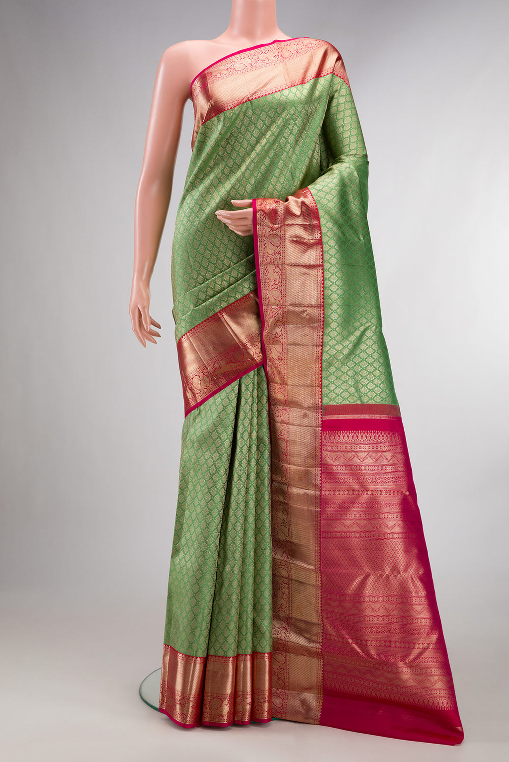 Pure Silk Pista Green Kanjivaram Saree with Zari Brocade on the body and Zari Border.  displayed on a mannequin