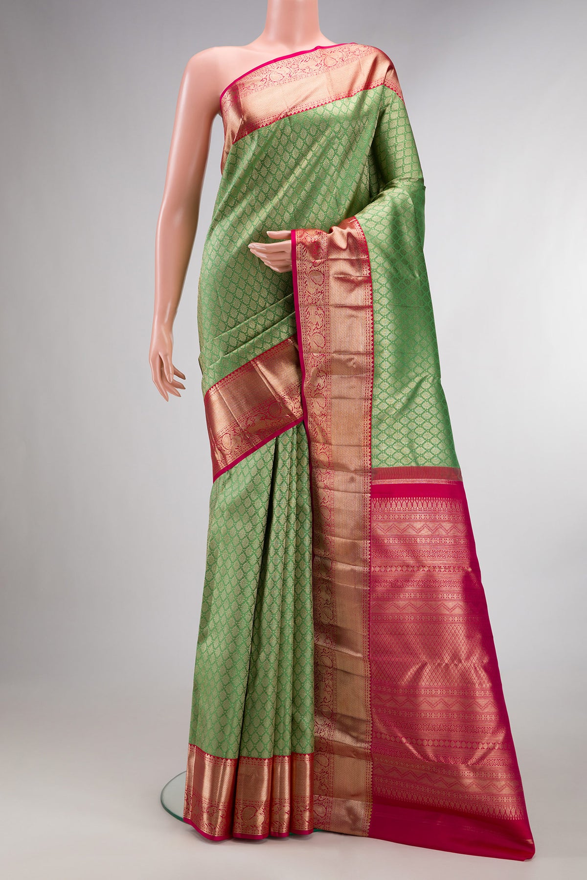 Pure Silk Pista Green Kanjivaram Saree with Zari Brocade on the body and Zari Border.  displayed on a mannequin
