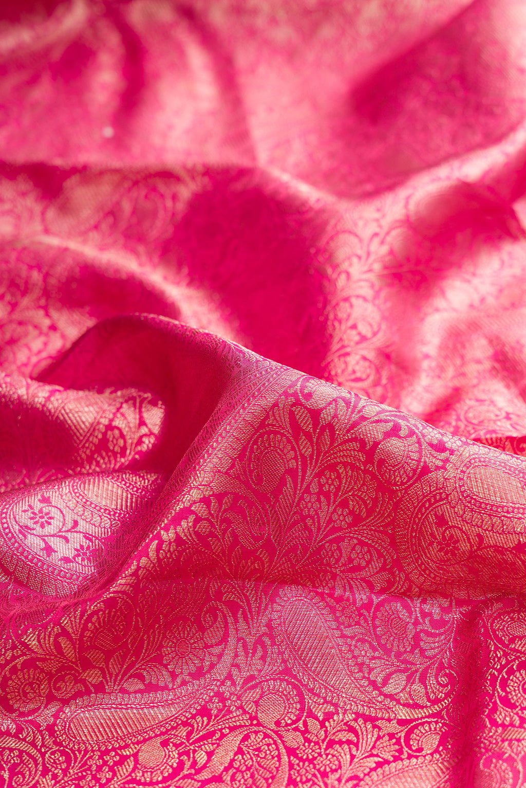 Close up of Pure Silk Pink Kanjivaram Saree with Zari Brocade on the body and Zari Border.  displaying folds
