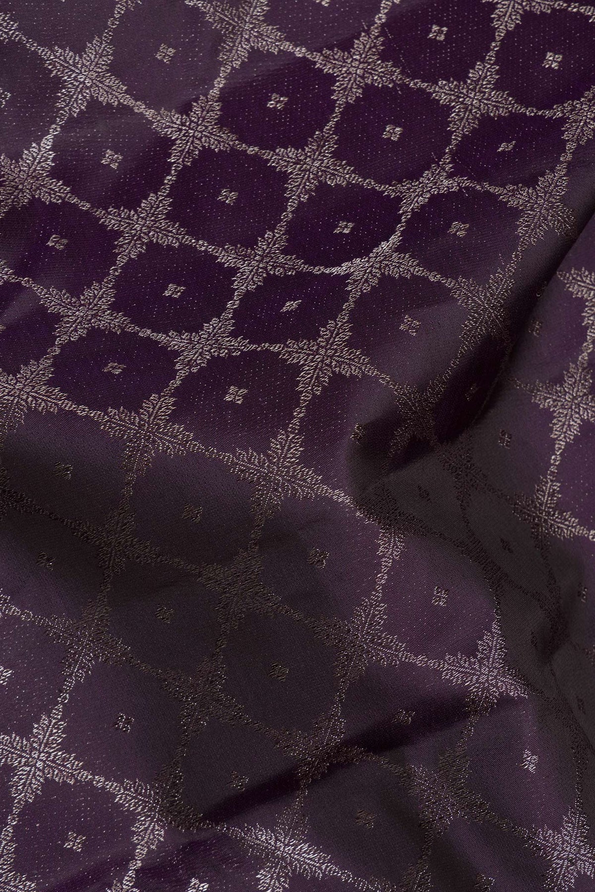 Close up of Pure Silk Burgundy Dual Tone Kanjivaram Saree with Zari Brocade on the body and Fancy Border.  displaying folds
