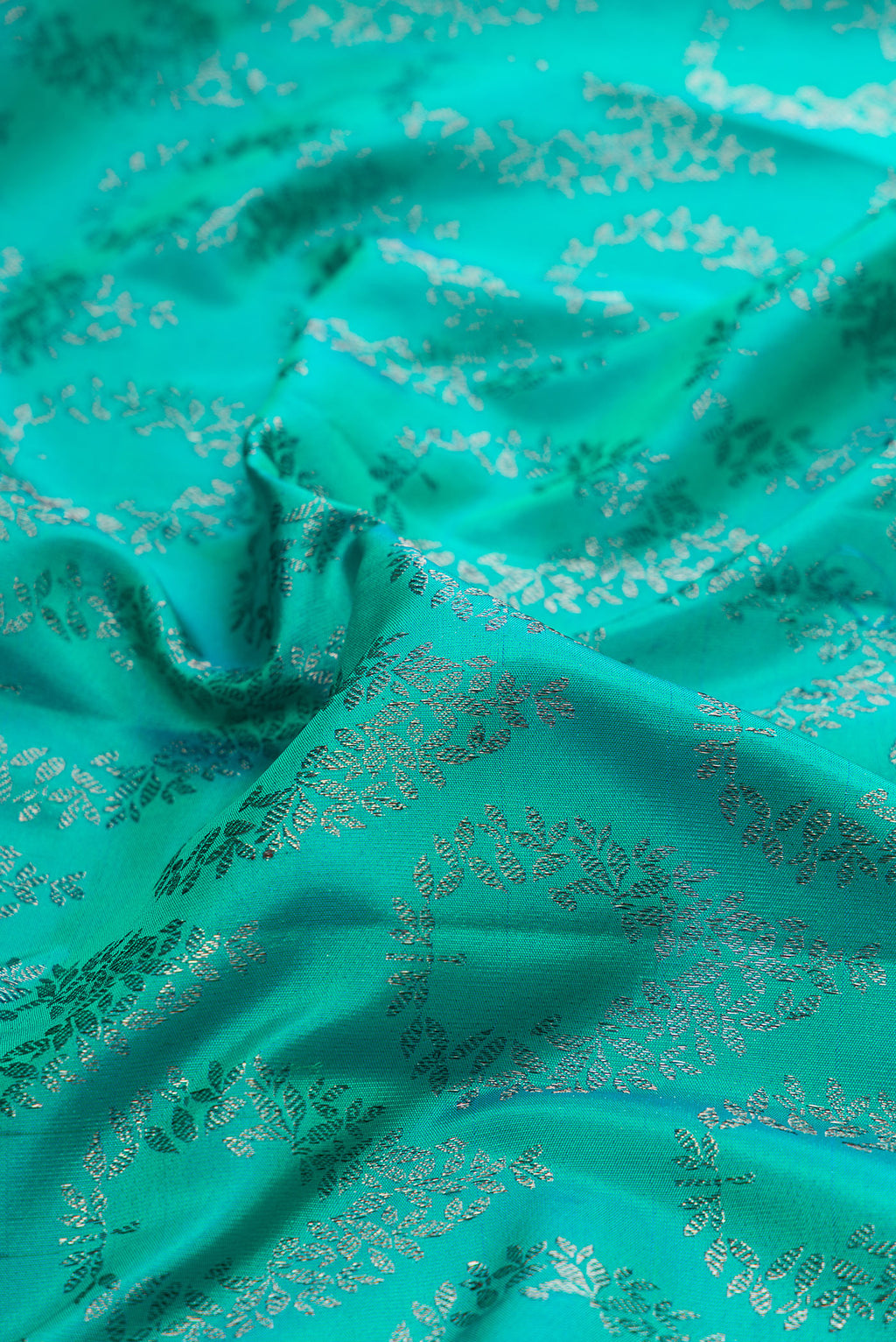 Close up of Pure Silk Sea Green Dual Tone Kanjivaram Saree with Zari Brocade on the body and Fancy Border.  displaying folds