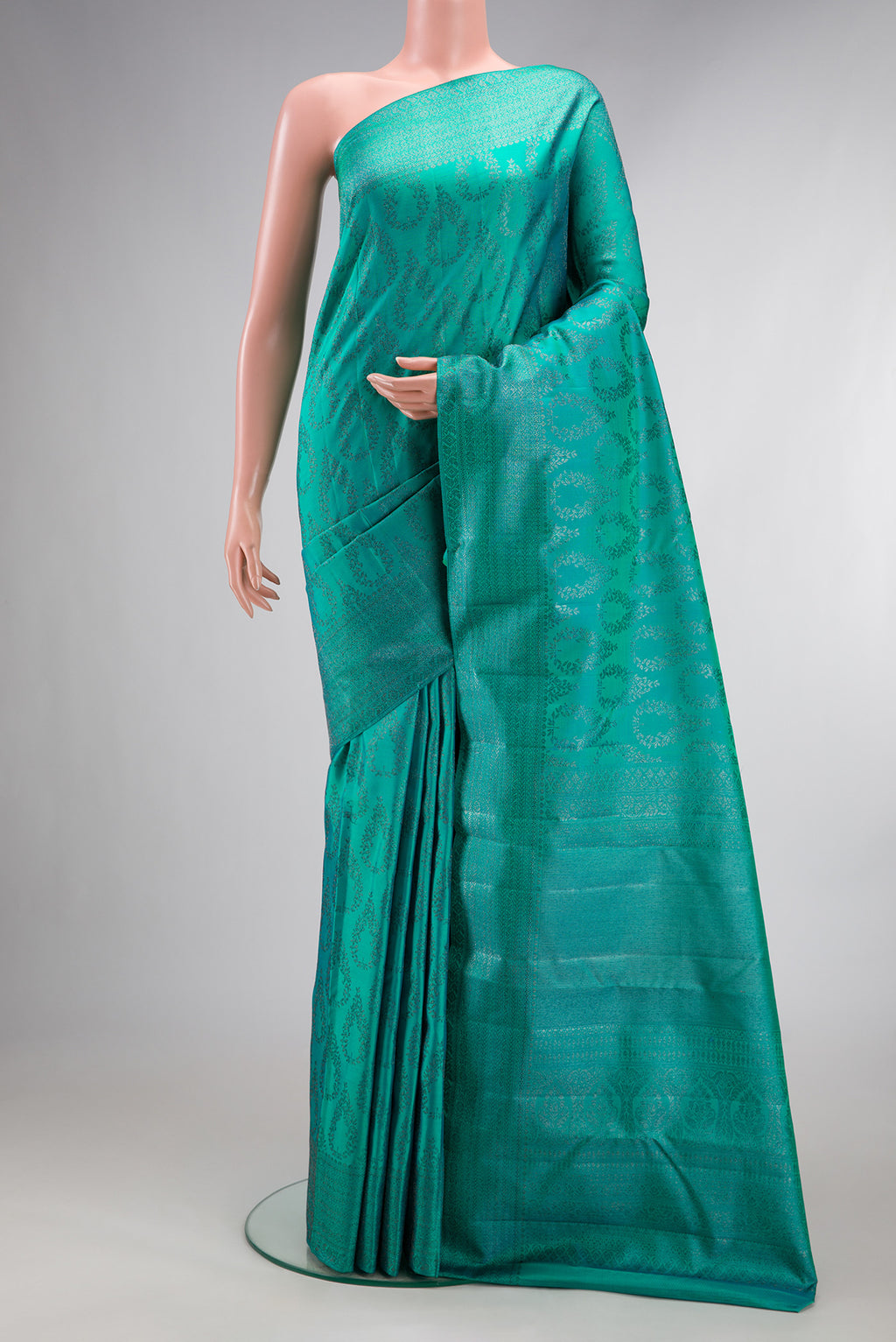 Pure Silk Sea Green Dual Tone Kanjivaram Saree with Zari Brocade on the body and Fancy Border.  displayed on a mannequin