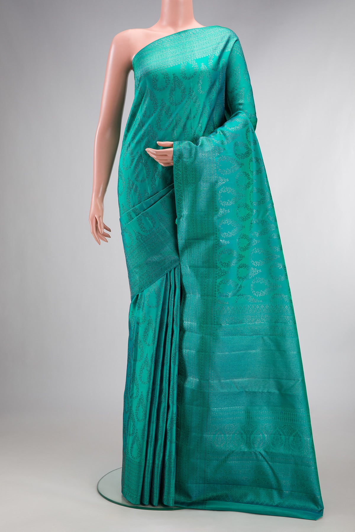 Pure Silk Sea Green Dual Tone Kanjivaram Saree with Zari Brocade on the body and Fancy Border.  displayed on a mannequin
