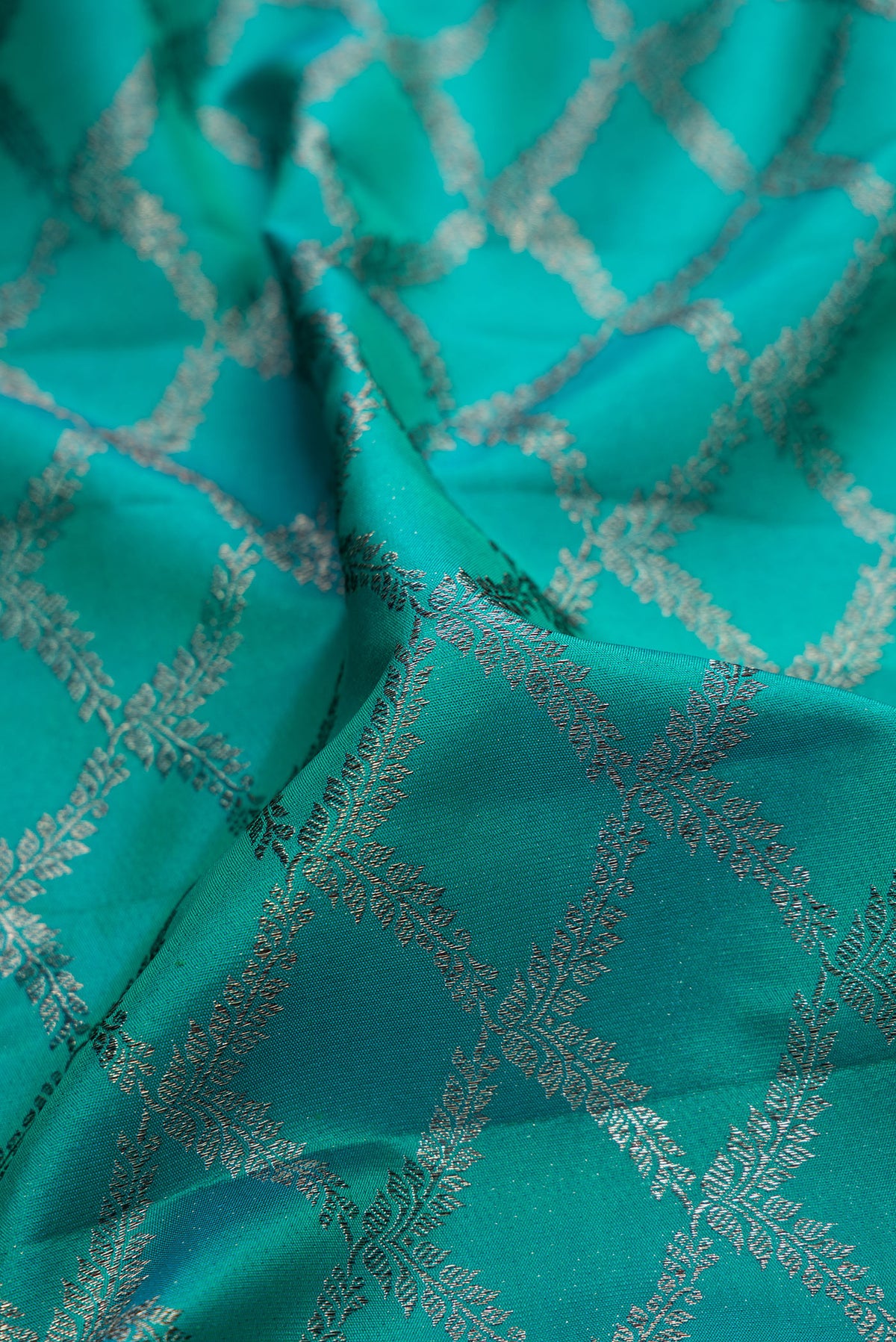 Close up of Pure Silk Turquoise Kanjivaram Saree with Zari Brocade on the body and Fancy Border.  displaying folds