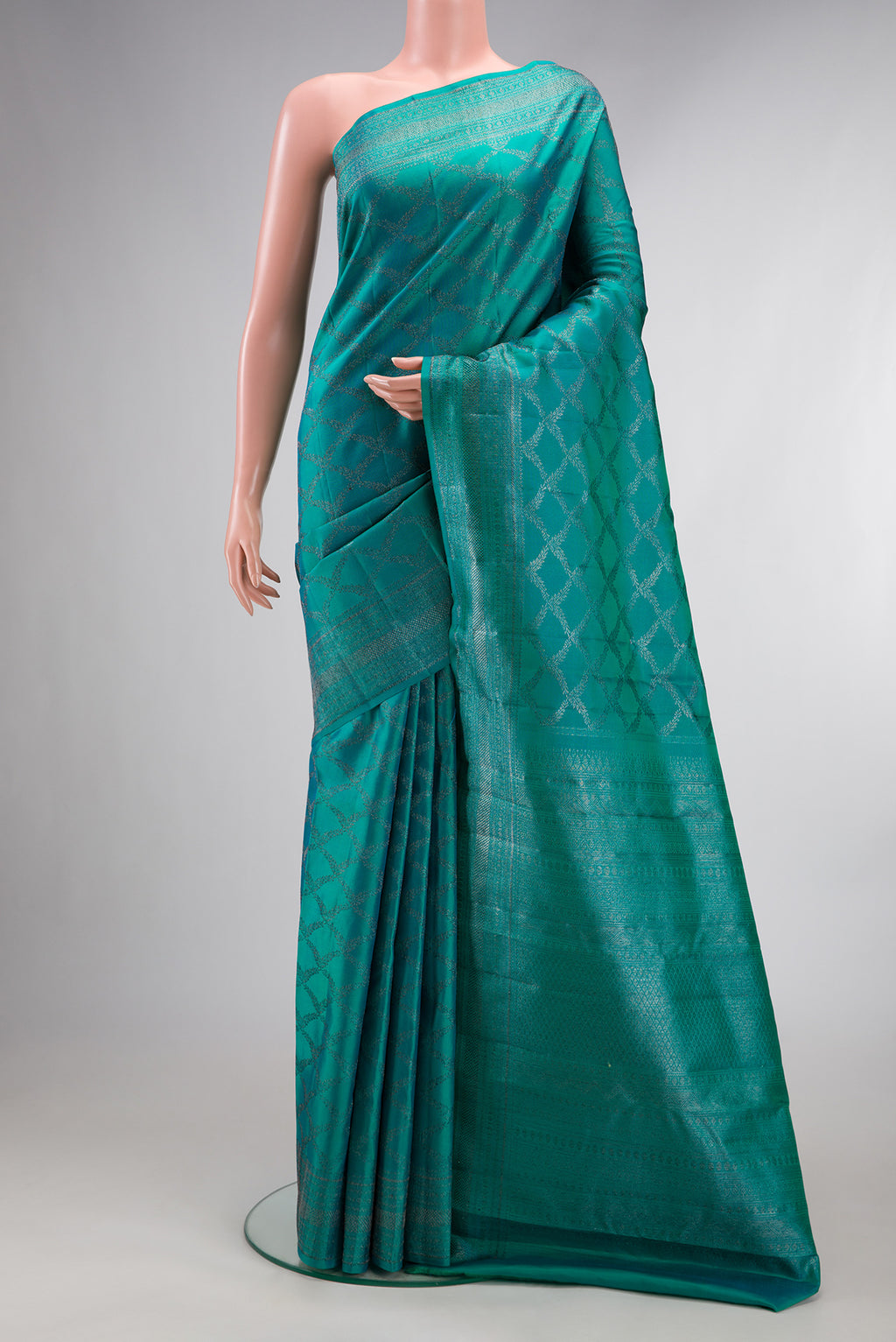 Pure Silk Turquoise Kanjivaram Saree with Zari Brocade on the body and Fancy Border.  displayed on a mannequin