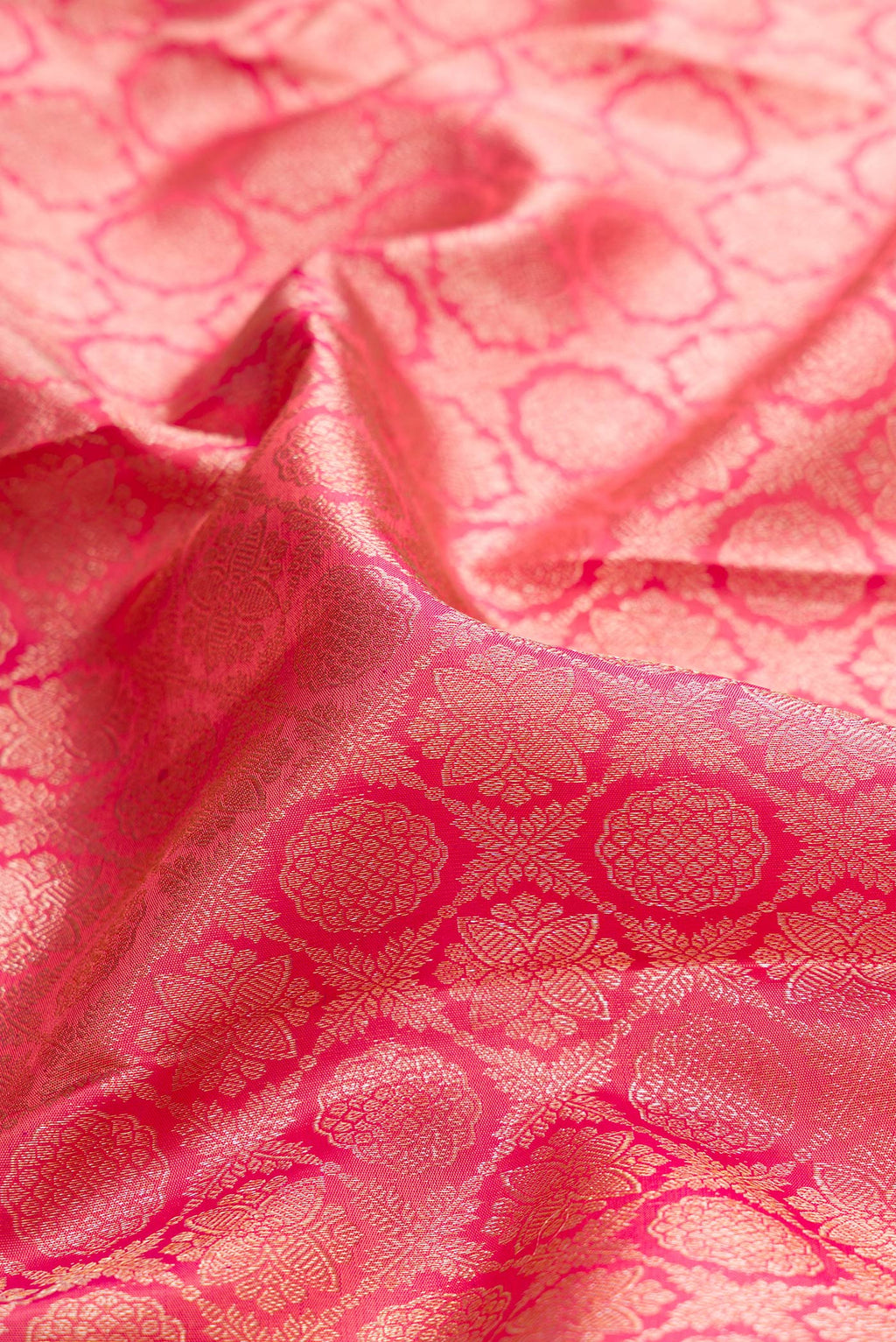 Close up of Pure Silk Coral Dual Tone Kanjivaram Saree with Zari Brocade on the body and Zari Border.  displaying folds