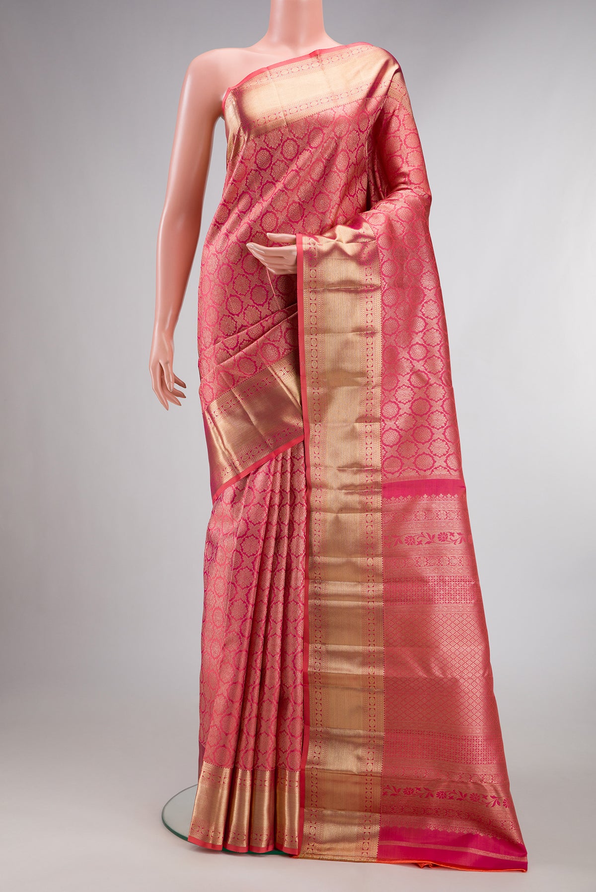 Pure Silk Coral Dual Tone Kanjivaram Saree with Zari Brocade on the body and Zari Border.  displayed on a mannequin