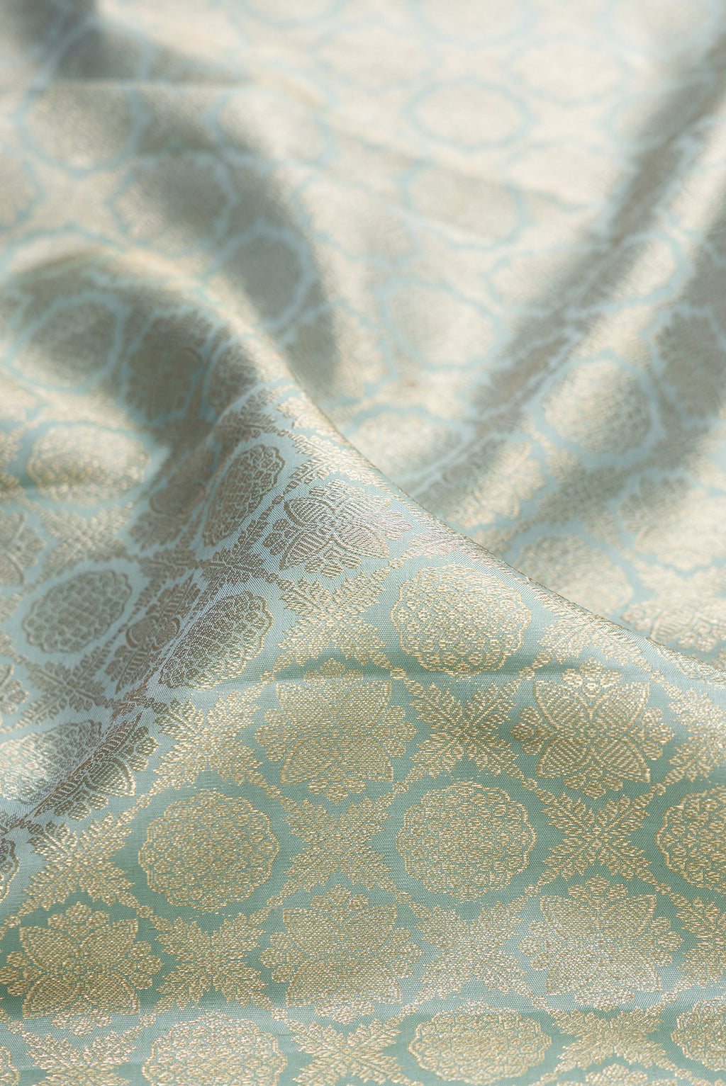Close up of Pure Silk Grey Kanjivaram Saree with Zari Brocade on the body and Zari Border.  displaying folds