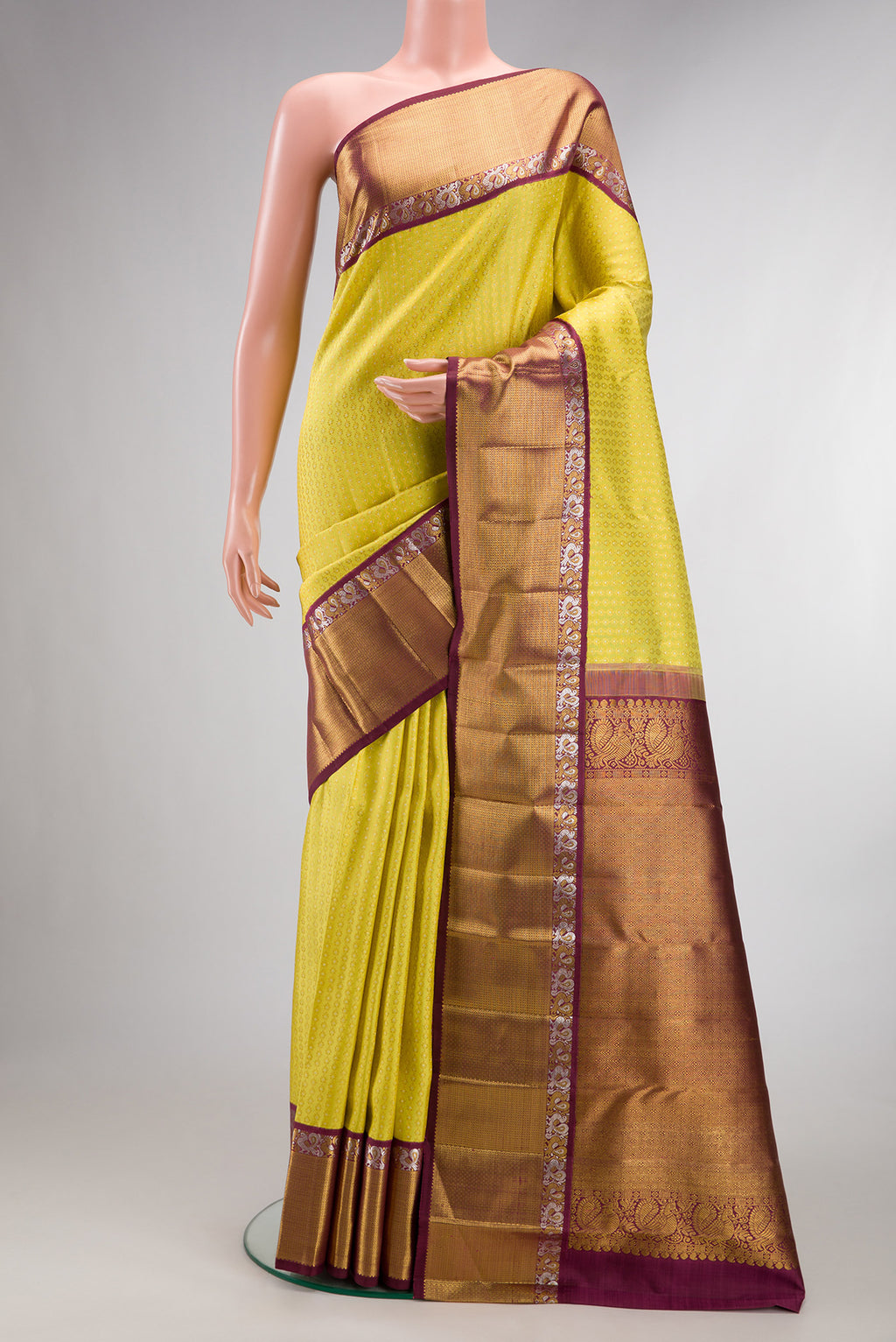 Pure Silk Yellow Dual Tone Kanchipuram Saree with Zari Brocade on the body and Zari Border.  displayed on a mannequin