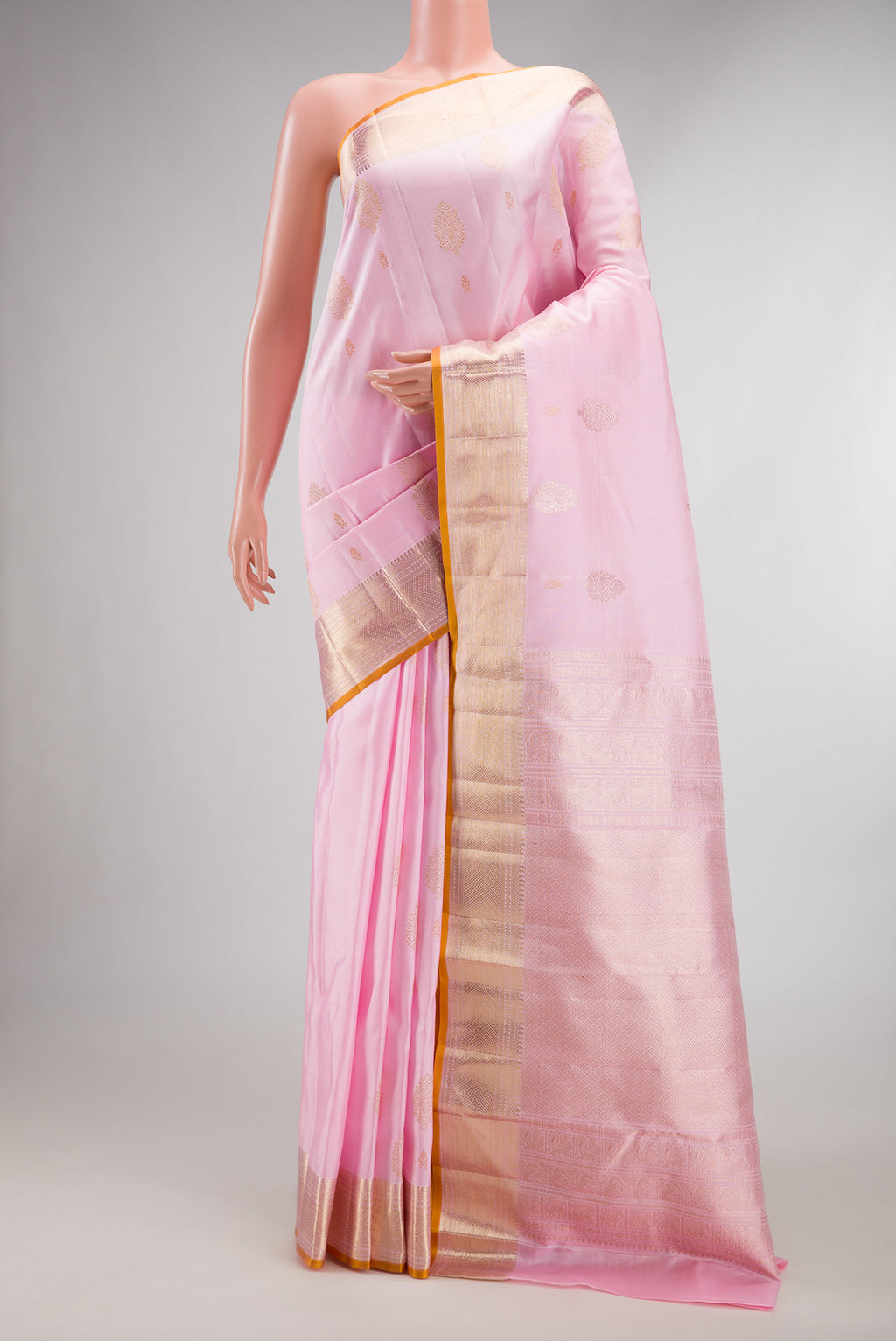 Pure Silk Rose pink Kanjivaram Saree with Zari Butta on the body and Zari Border.  displayed on a mannequin