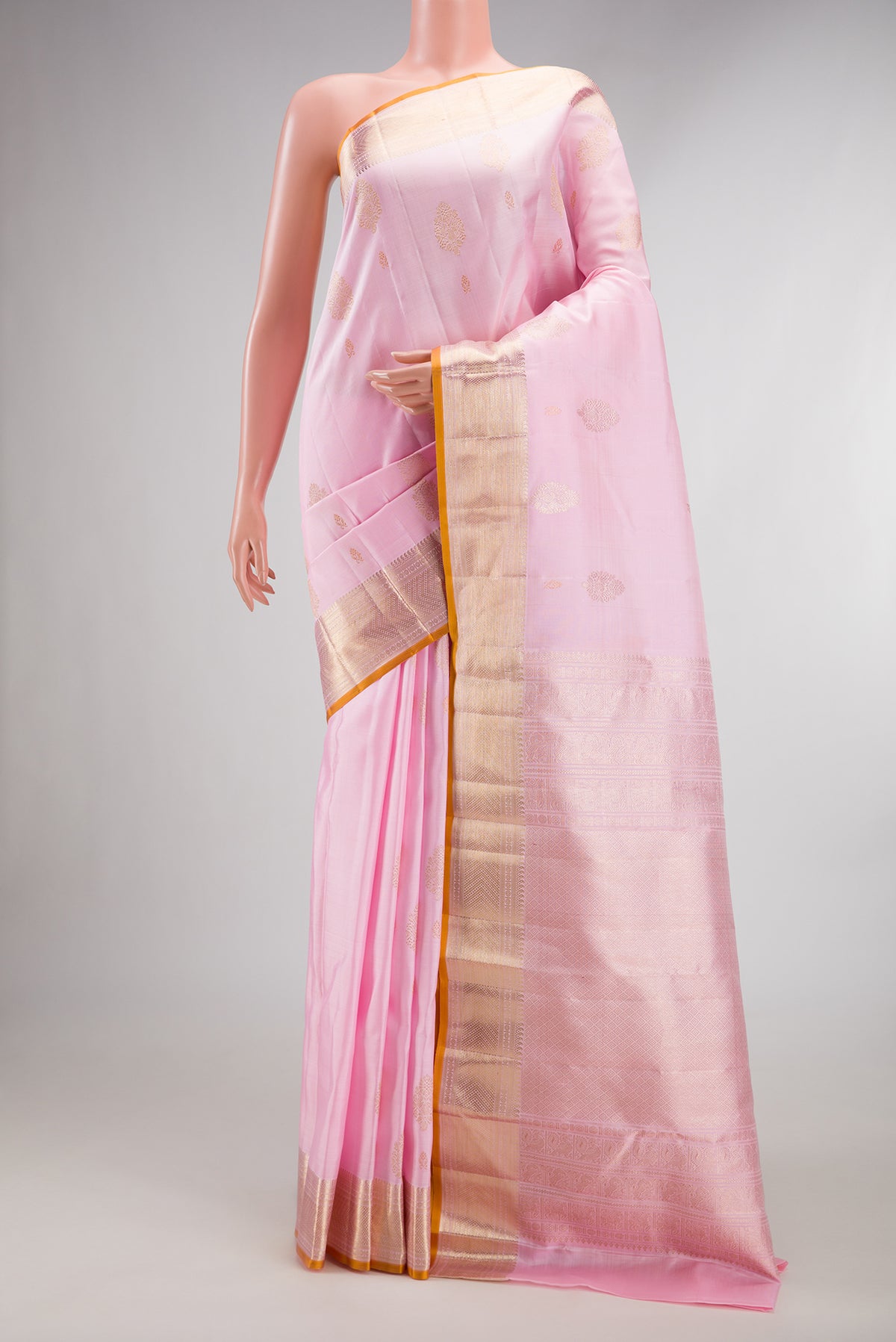 Pure Silk Rose pink Kanjivaram Saree with Zari Butta on the body and Zari Border.  displayed on a mannequin