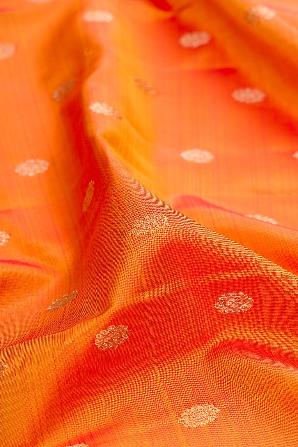 Close up of Pure Silk Mustard Kanjivaram Saree with Zari Butta on the body and Zari Border.  displaying folds