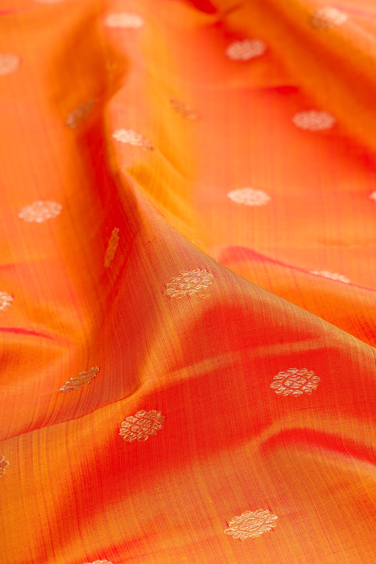 Close up of Pure Silk Mustard Kanjivaram Saree with Zari Butta on the body and Zari Border.  displaying folds