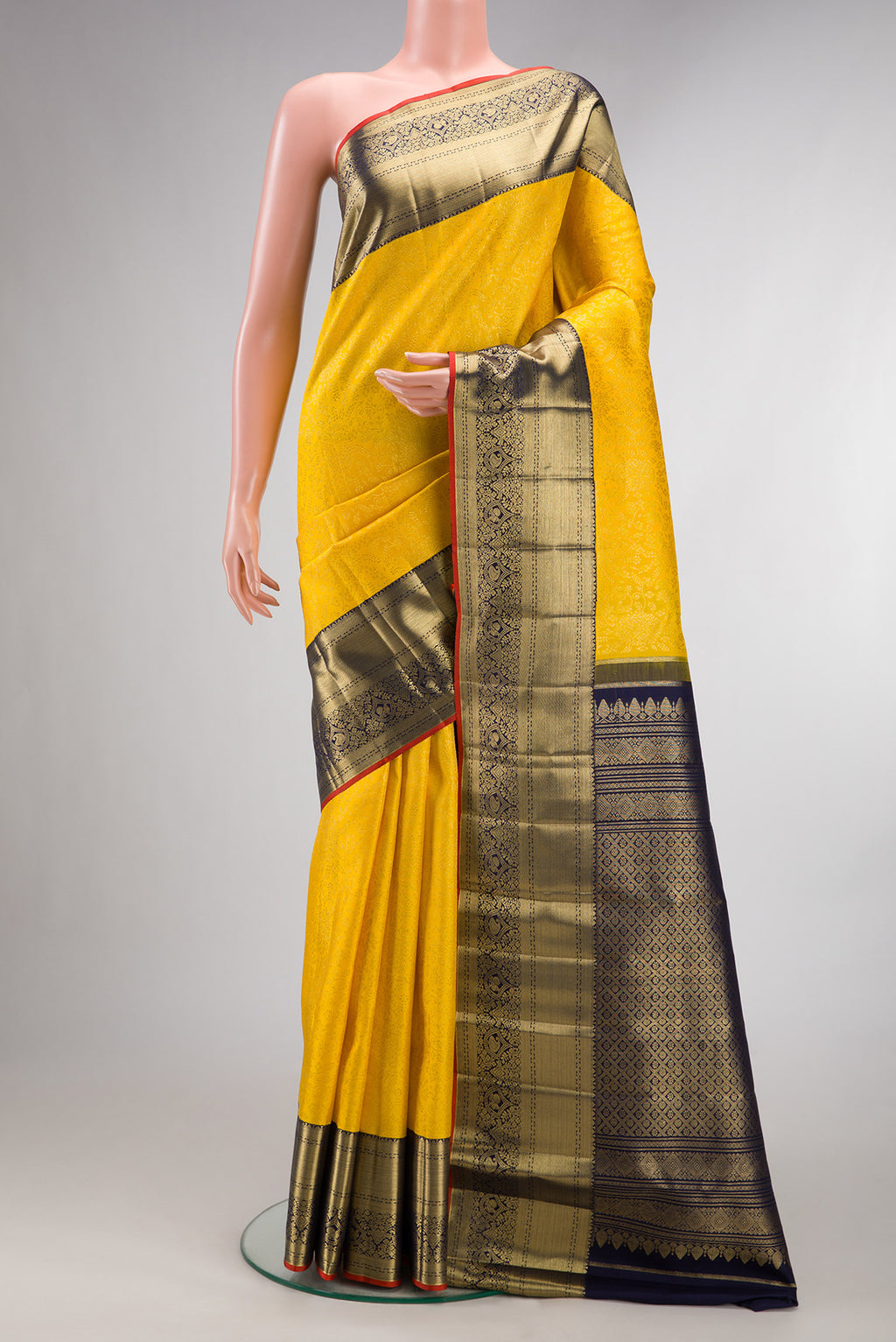 Pure Silk Yellow Kanchipuram Saree with Zari Brocade on the body and Zari Border.  displayed on a mannequin