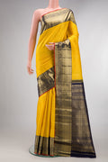 Pure Silk Yellow Kanchipuram Saree with Zari Brocade on the body and Zari Border.  displayed on a mannequin