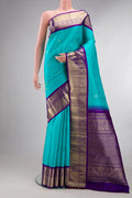 Pure Silk Sky Blue Kanjivaram Saree with Zari Butta on the body and Zari Border.  displayed on a mannequin