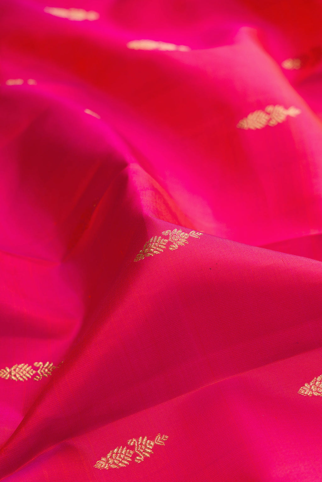 Close up of Pure Silk Pink Kanjivaram Saree with Zari Butta on the body and Zari Border.  displaying folds