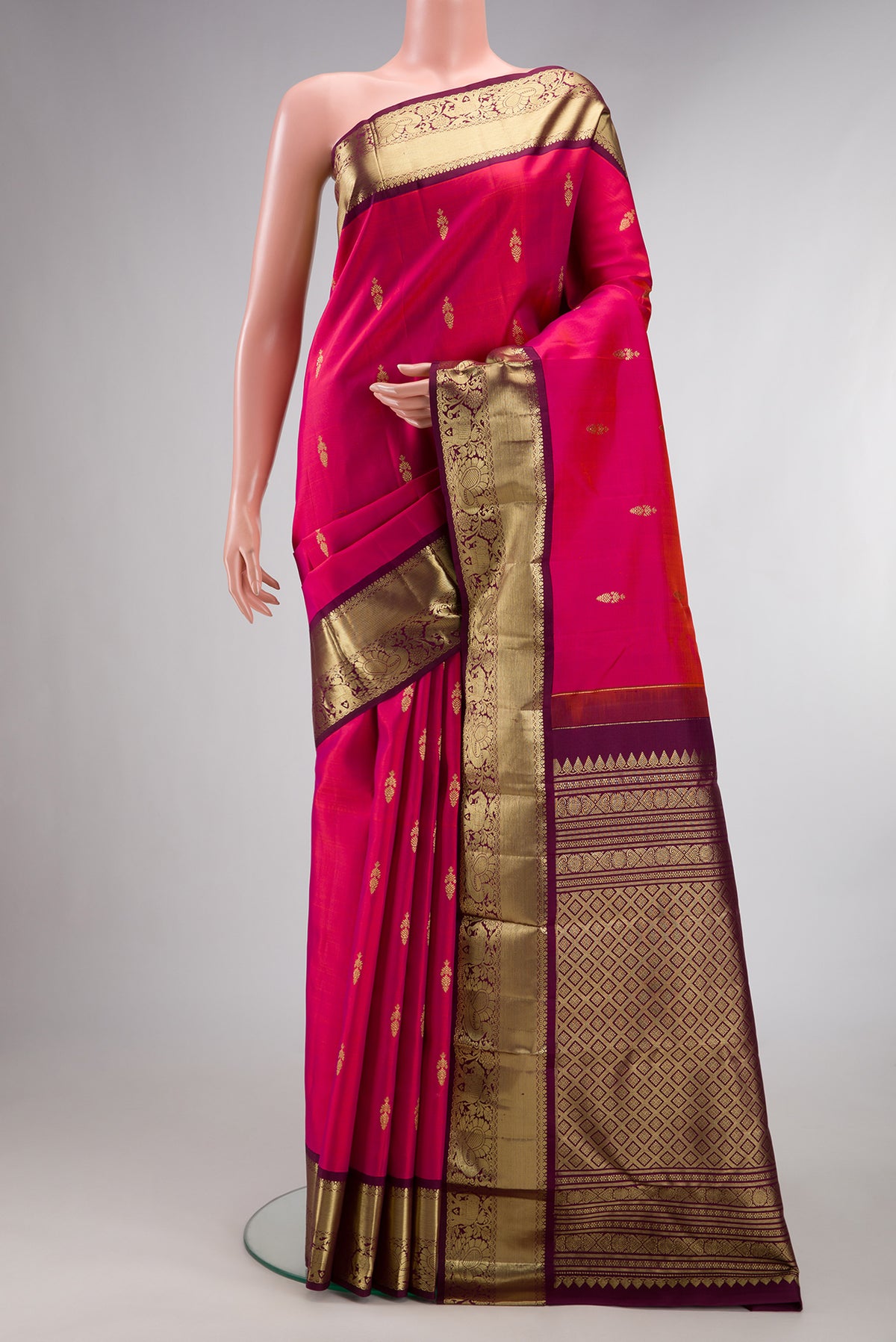 Pure Silk Pink Kanjivaram Saree with Zari Butta on the body and Zari Border.  displayed on a mannequin