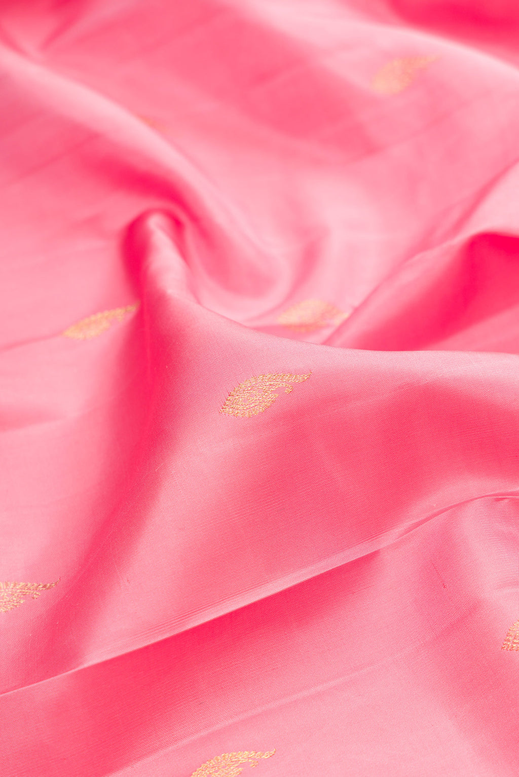 Close up of Pure Silk Pink Kanjivaram Saree with Zari Butta on the body and Fancy Border.  displaying folds