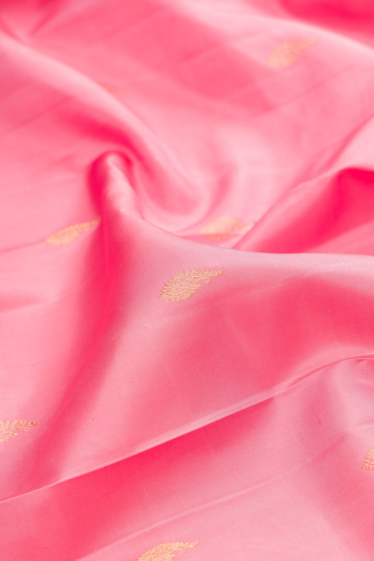 Close up of Pure Silk Pink Kanjivaram Saree with Zari Butta on the body and Fancy Border.  displaying folds